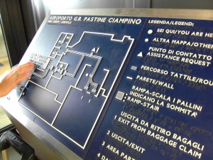 Colour photograph showing a good example of a Braille Map, having strong colour contrast and with texts in Italian and English, at the Arrivals Building Main Entrance/Exit in Rome's Ciampino Airport. Photograph by CJ Walsh. 2011-10-26. Click to enlarge.
