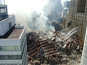 Colour photograph showing World Trade Center Building No. 7 in ruins, after 9-11 in New York City ... when Fire-Induced Progressive Damage led to Disproportionate Damage, and finally to total building failure ... a Collapse Level Event (CLE) which is entirely unacceptable to the general population of any community or society. Click to enlarge.