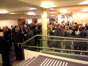 Colour photograph showing Delegates at the 2012 IIEA/TEPSA Irish EU Presidency Conference in Dublin - described by one journalist as "a heavyweight audience of policymakers and 'leading thinkers' " - chatting over morning coffee and tea. Notice the lethal-looking metal handrail extensions in the foreground. Photograph taken by CJ Walsh. 2012-11-23. Click to enlarge.